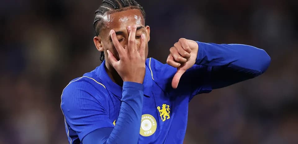 Player in blue jersey showing a thumbs down gesture