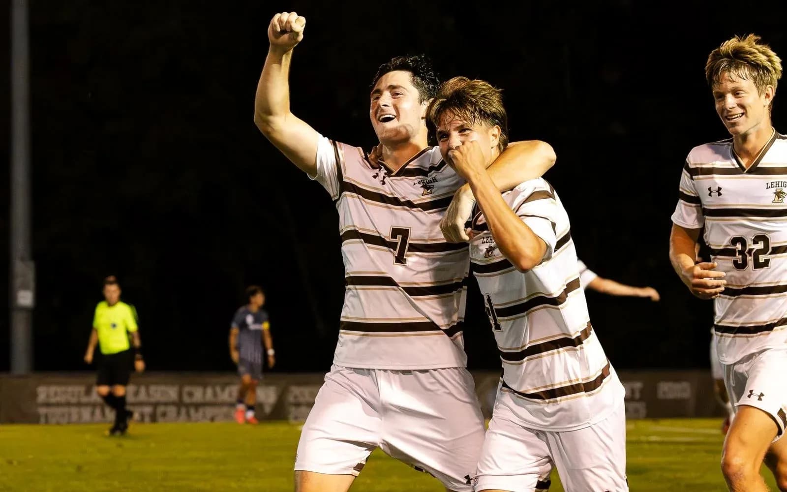 Players celebrating a goal on the soccer field