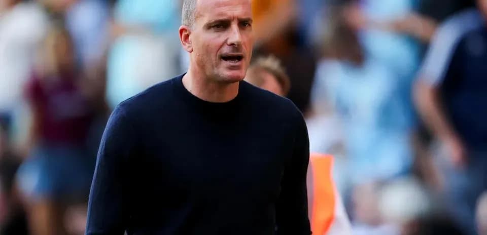 Coach speaking on the sideline during match
