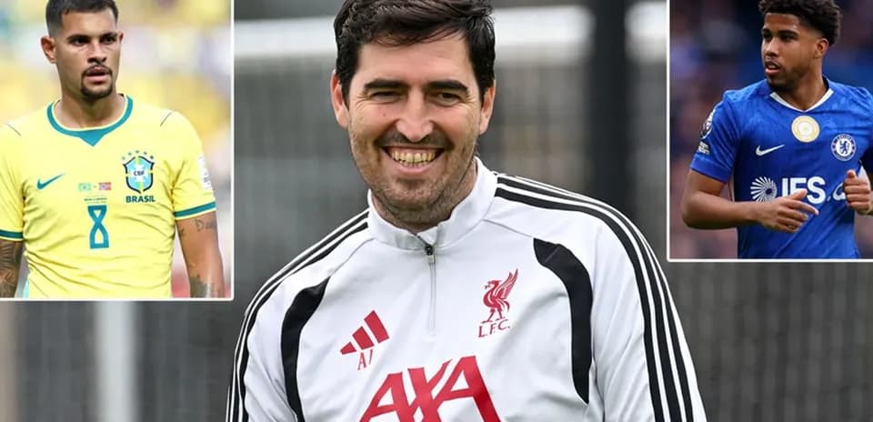Liverpool coach smiling with players' images in background
