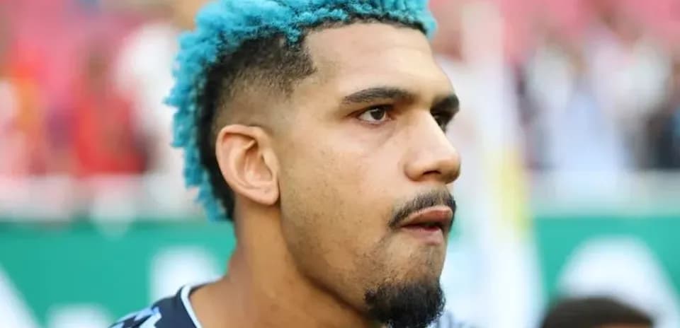 Goalkeeper with blue hair during pre-match warm-up