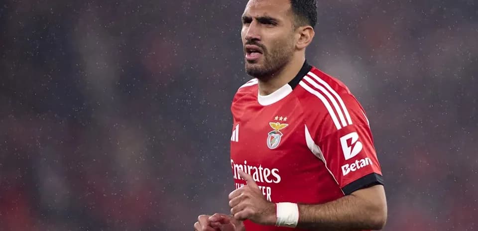 Player in red jersey during rainy match