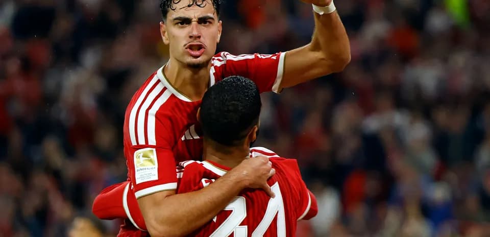 Player celebrating with teammate after scoring goal