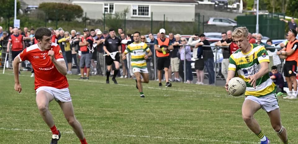 Player in yellow and green passing ball during match