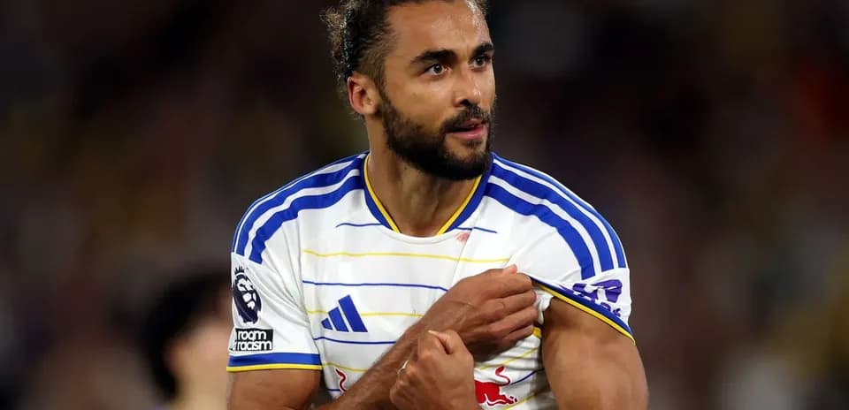 Player showing team badge during match celebration