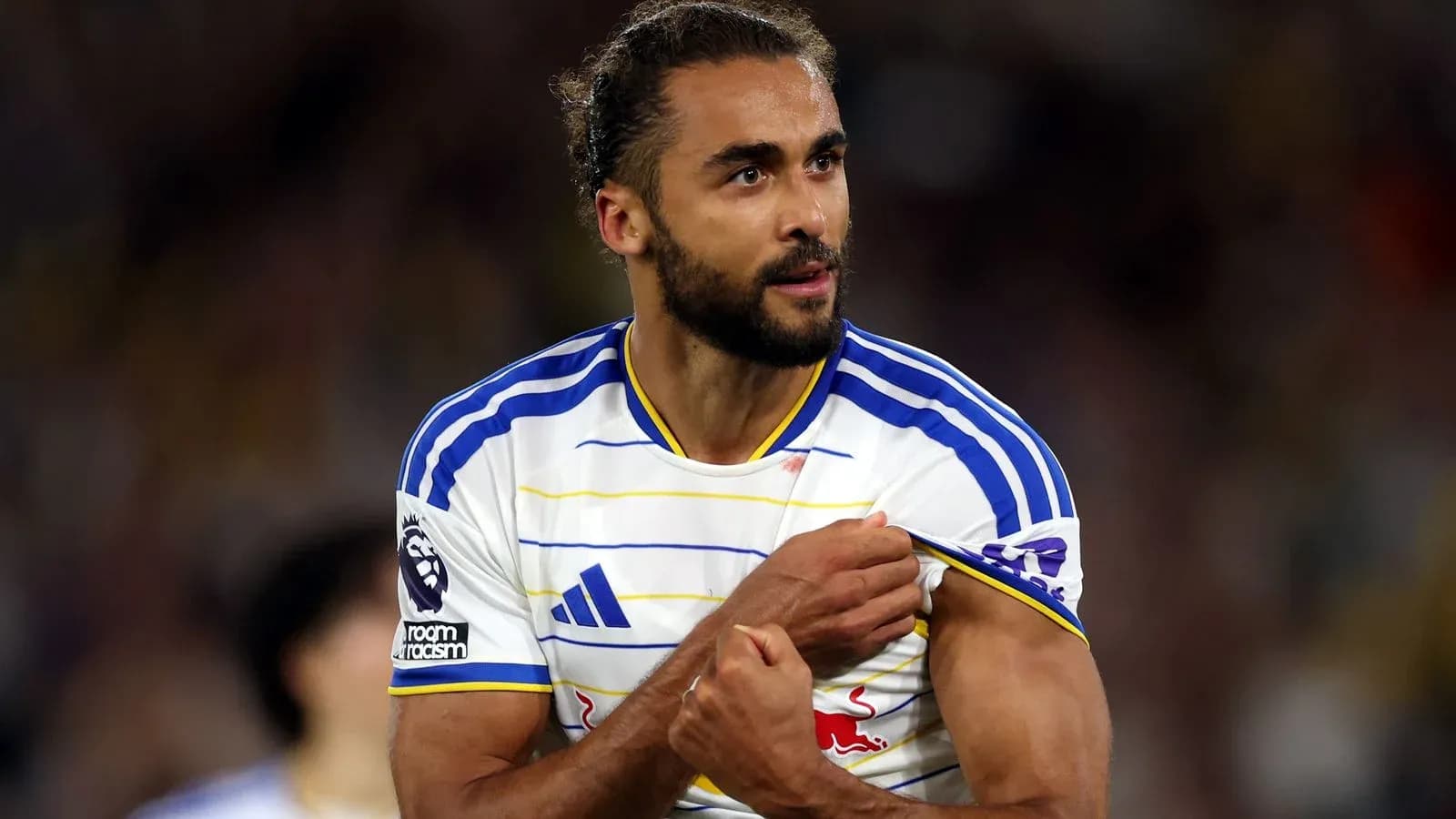 Player showing team badge during match celebration