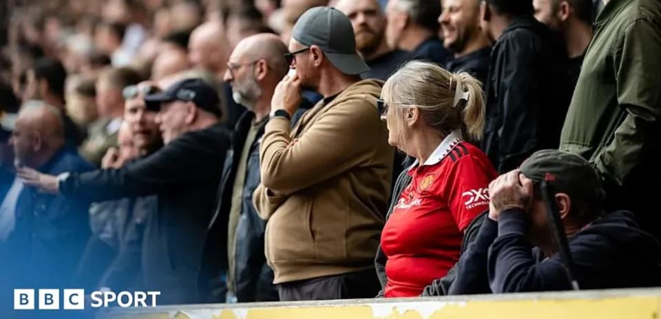 Fans watching a football match in the stands