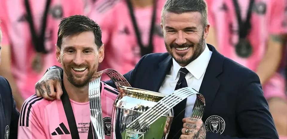 Lionel Messi and David Beckham celebrating with trophy
