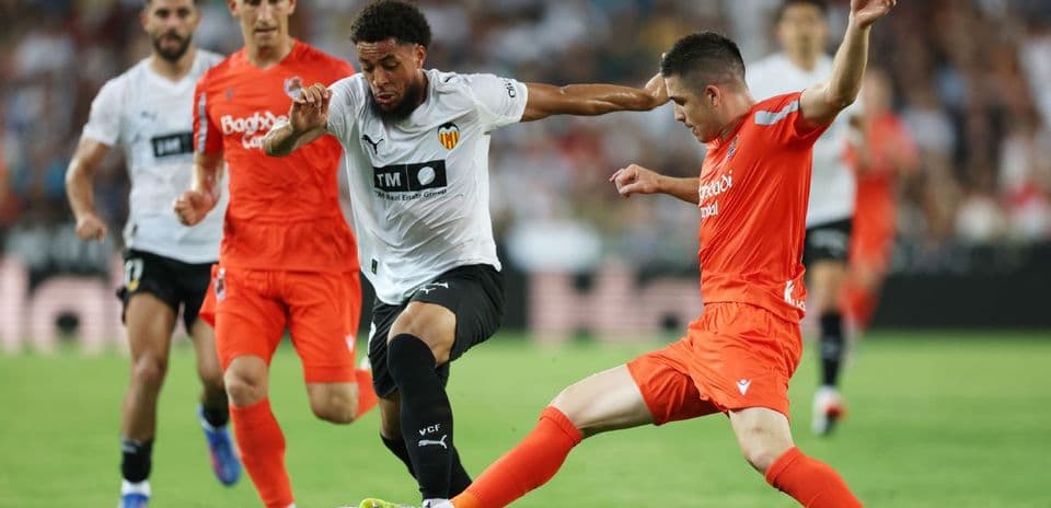 Players contesting for the ball in La Liga match