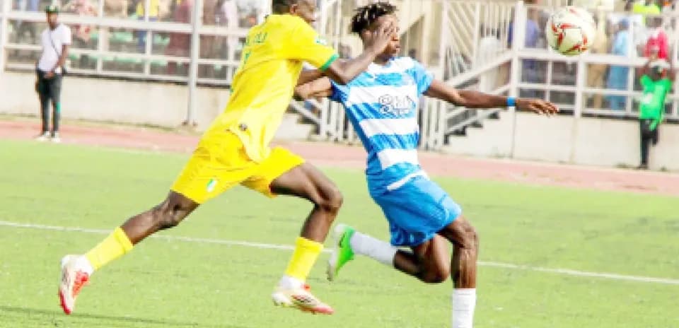 Ikorodu City player tackling Enugu Rangers opponent