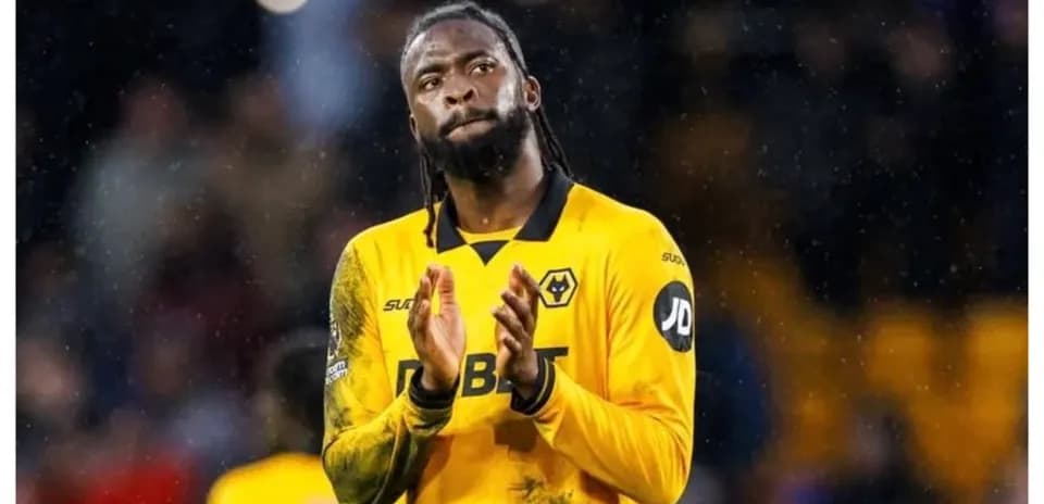 Player applauding fans in Wolves' yellow kit