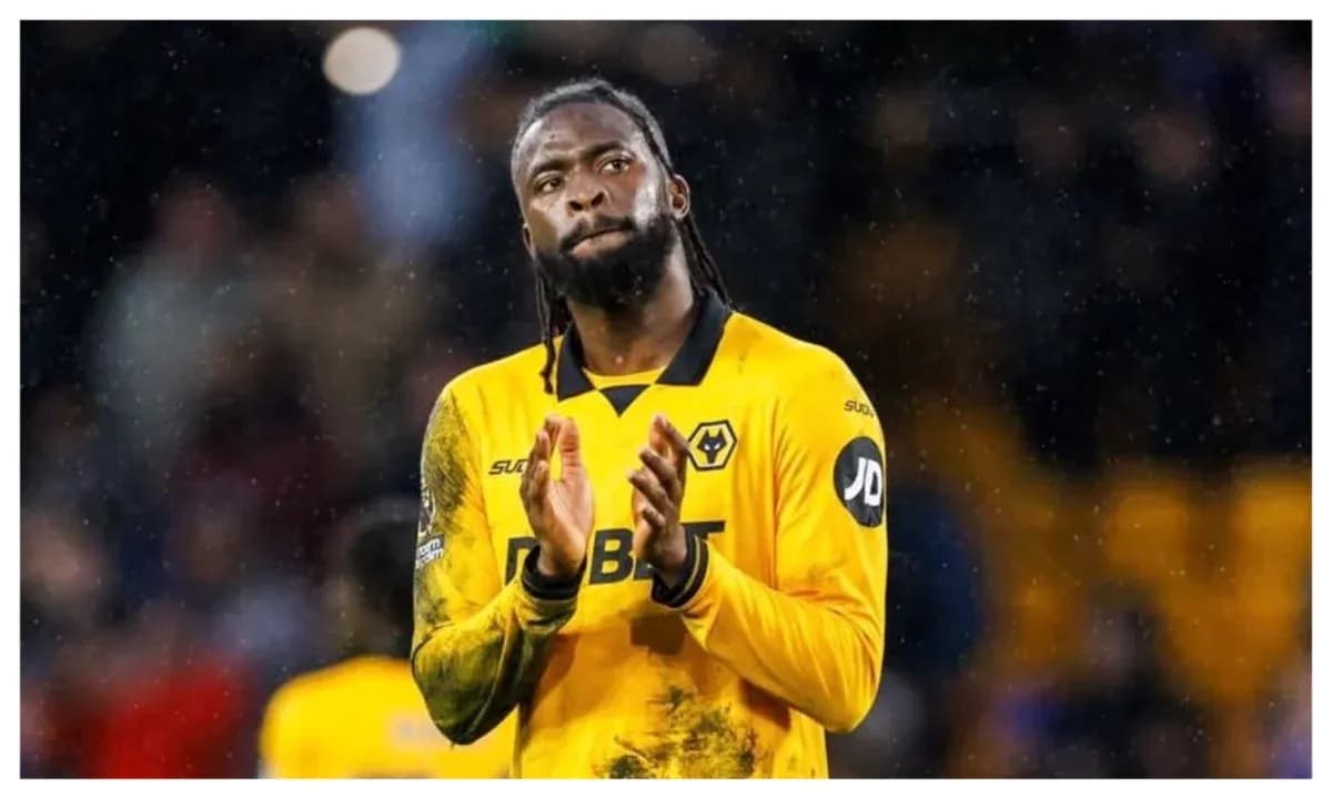 Player applauding fans in Wolves' yellow kit