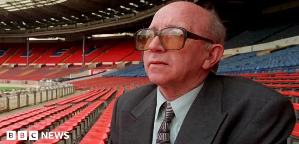 Person seated in empty stadium observing surroundings