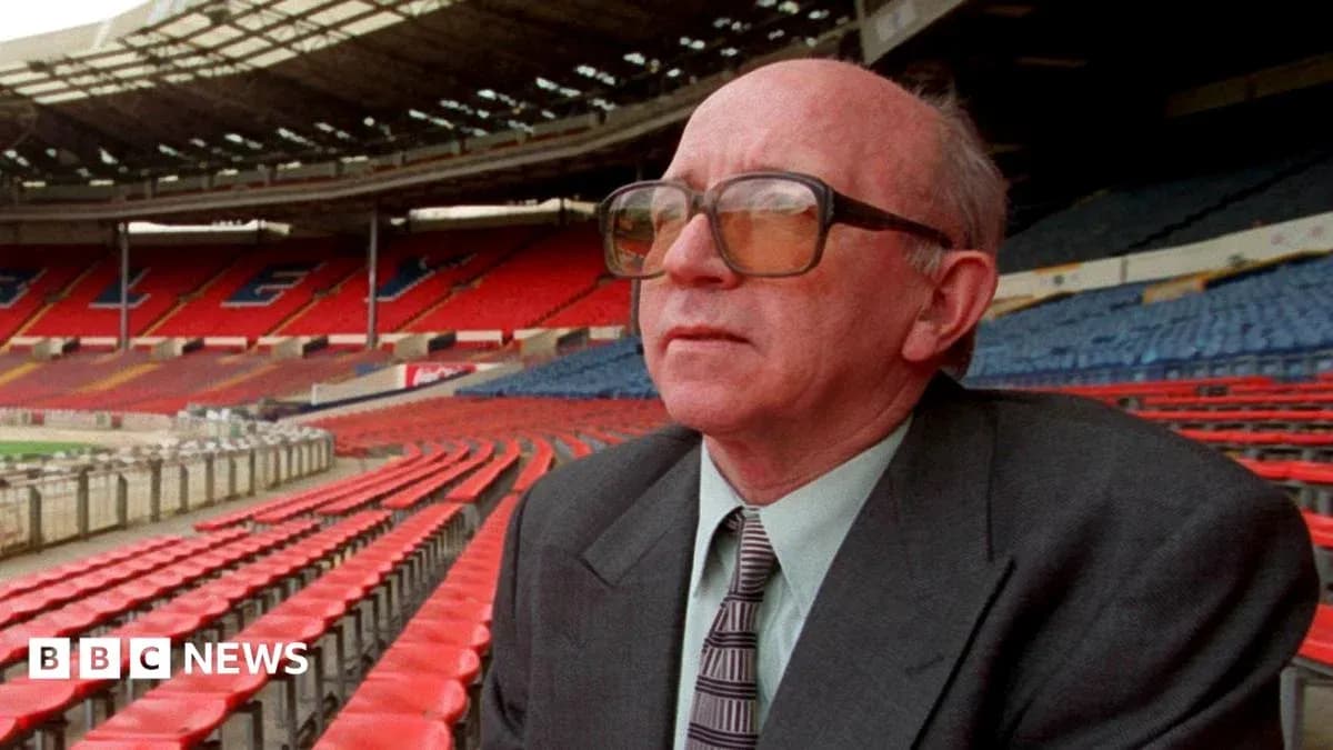 Person seated in empty stadium observing surroundings