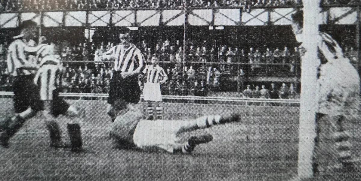 Players contesting a ball near the goalpost