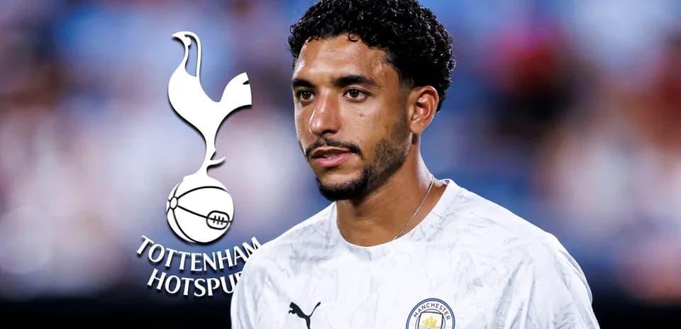 Player in Manchester City kit with club logos