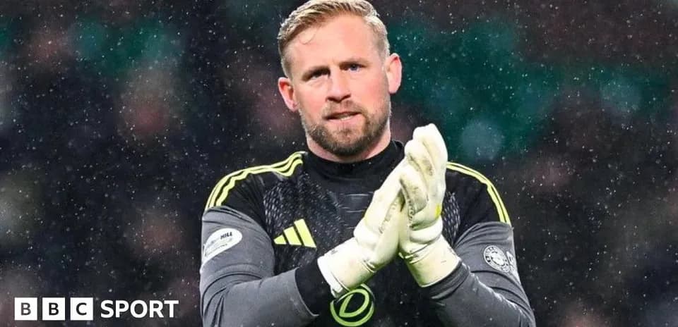 Goalkeeper applauding fans during snowy match