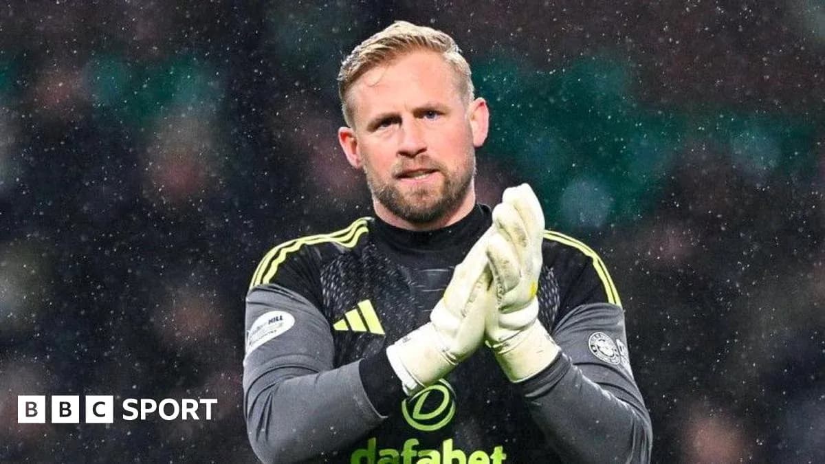 Goalkeeper applauding fans during snowy match