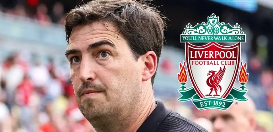 Coach with Liverpool FC logo in background