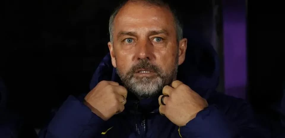 Coach adjusting jacket on the sidelines during match