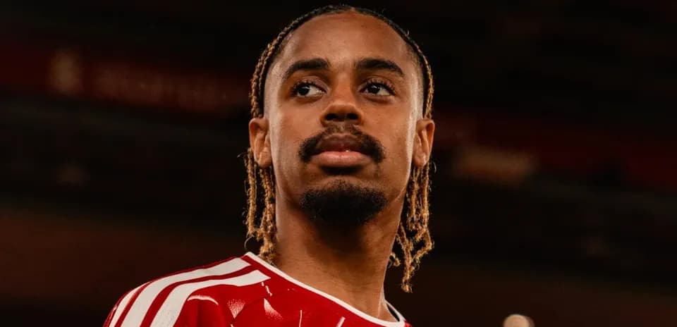 Player wearing red jersey posing for photo