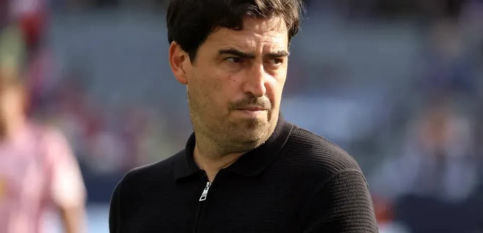 Coach observing players during warm-up before match