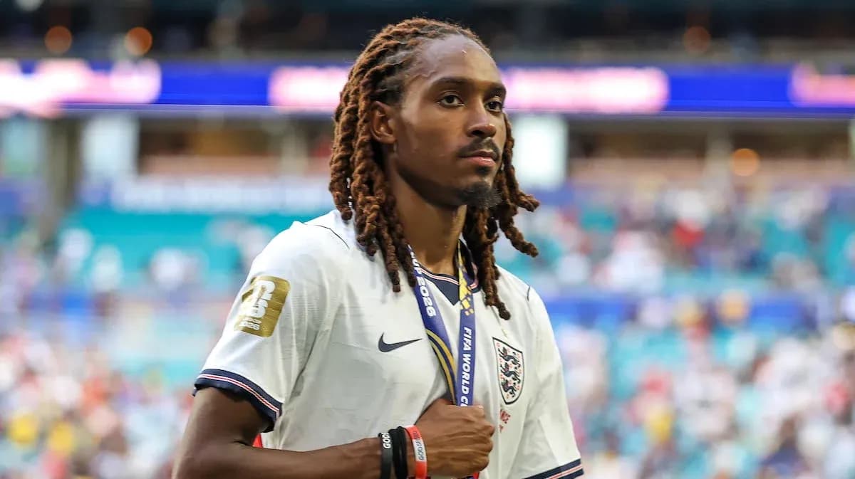 Player wearing England jersey with medal on field