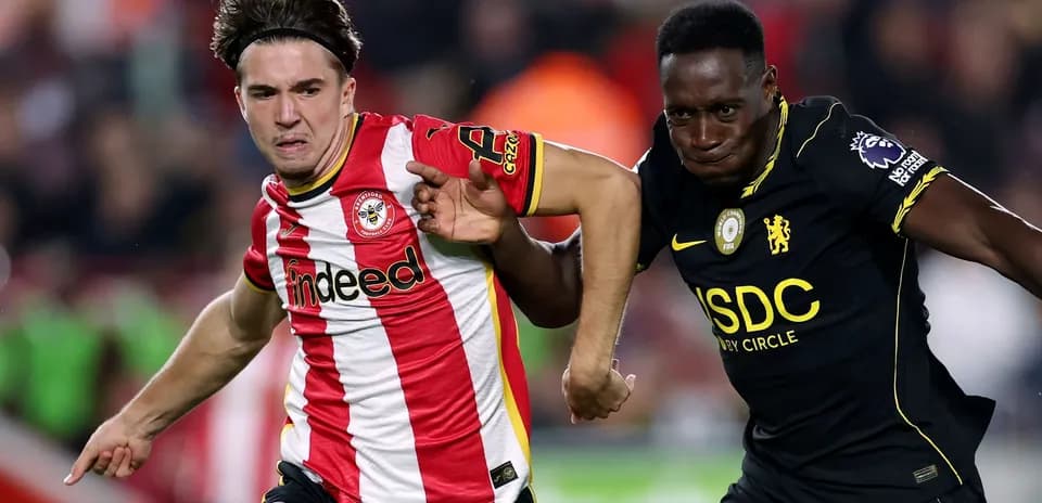 Brentford player racing against Chelsea player