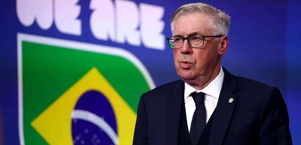 Coach speaking at press conference with Brazil logo