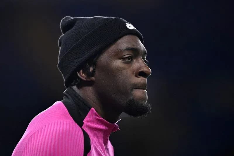 Athlete in pink training gear wearing a black beanie