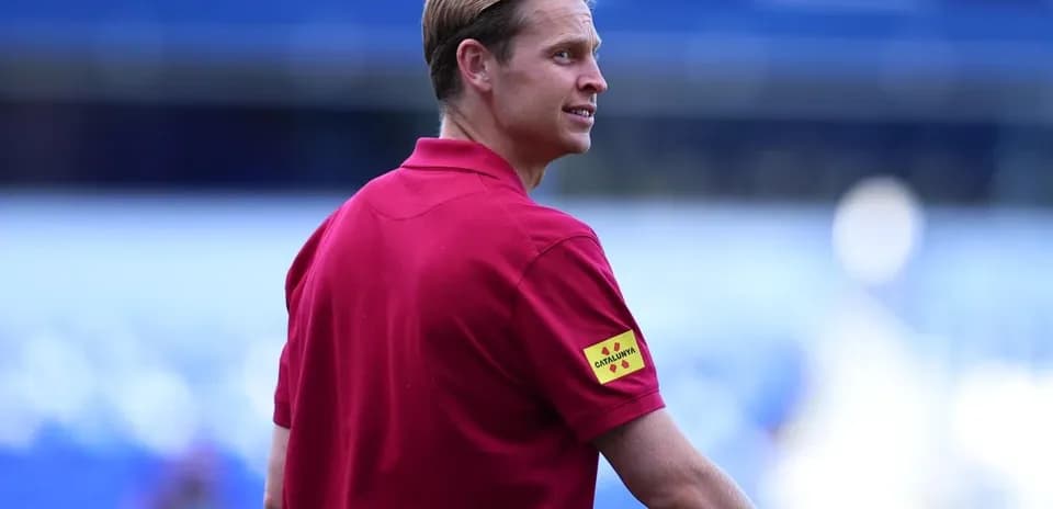 Referee in red shirt at football match