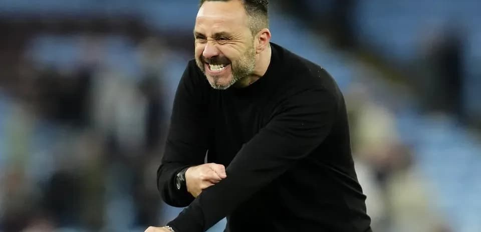 Coach celebrating passionately on the sidelines