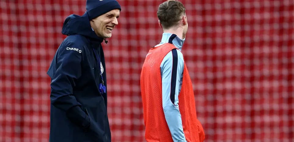Coach laughing with player during training session
