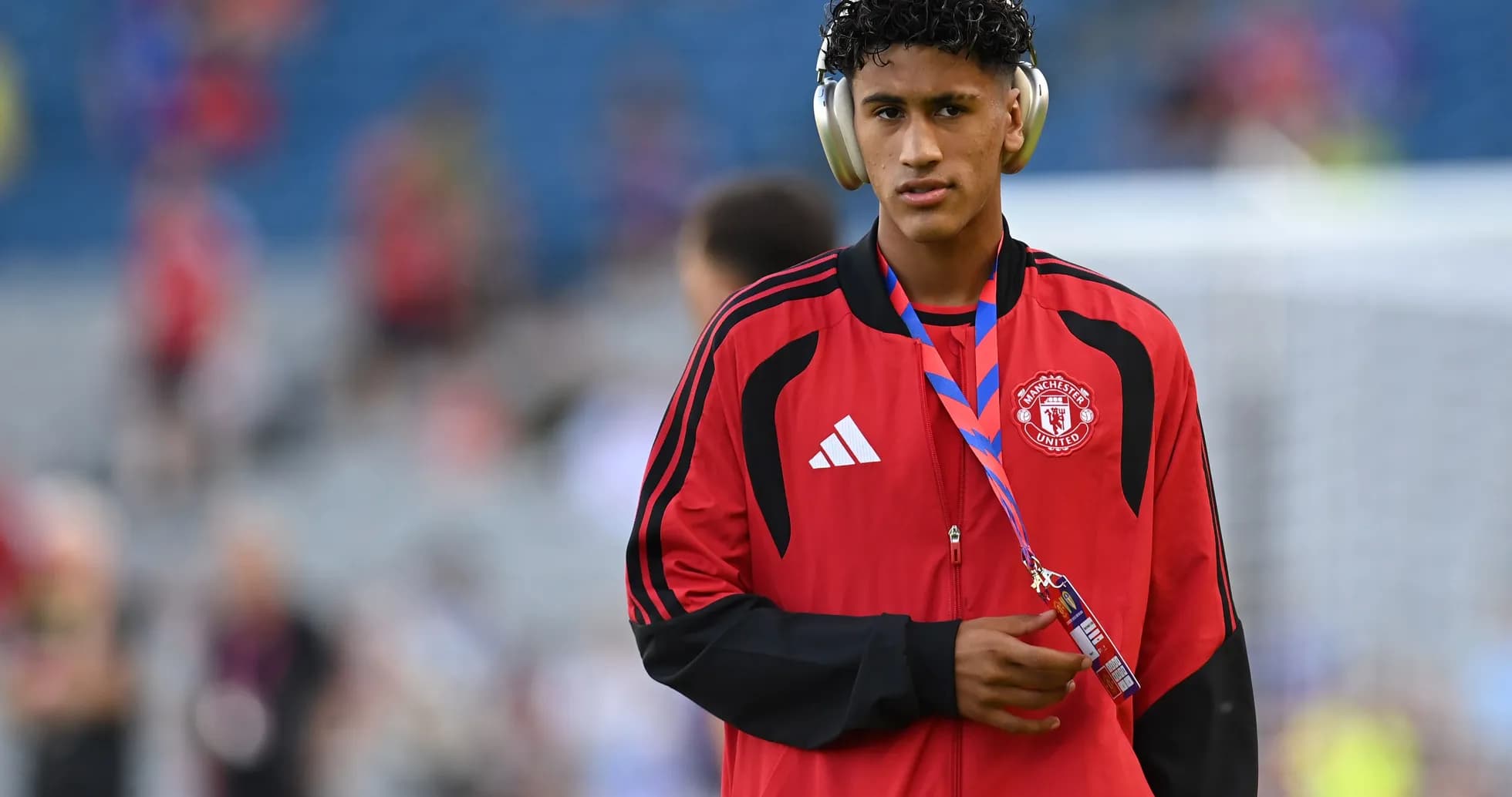 Player wearing headphones and Manchester United tracksuit