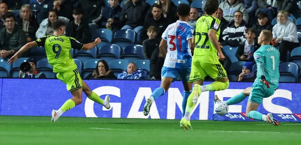 Player shooting on goal with goalkeeper in position