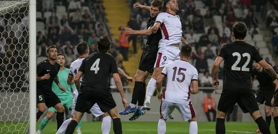 Players contesting a header near the goal