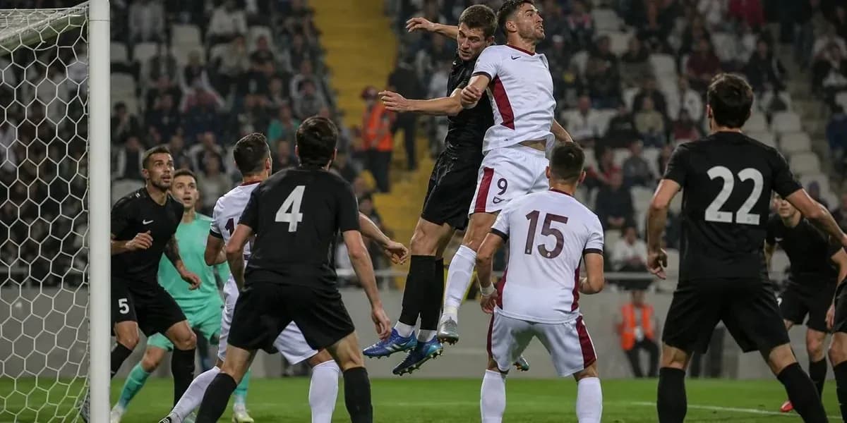 Players contesting a header near the goal