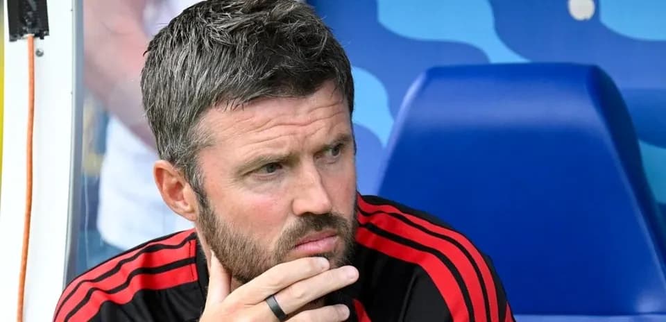 Coach sitting on bench during match contemplation