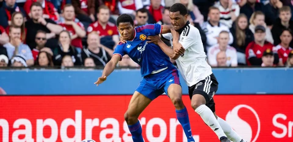 Two players battling for possession during match