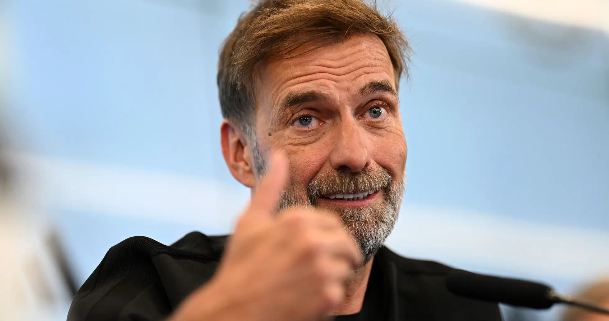 Manager giving a thumbs up during press conference