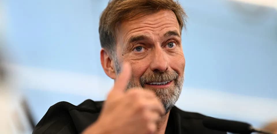 Manager giving a thumbs up during press conference