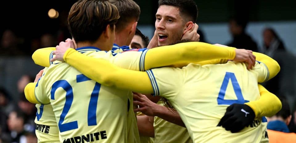 Players celebrating a goal during a match
