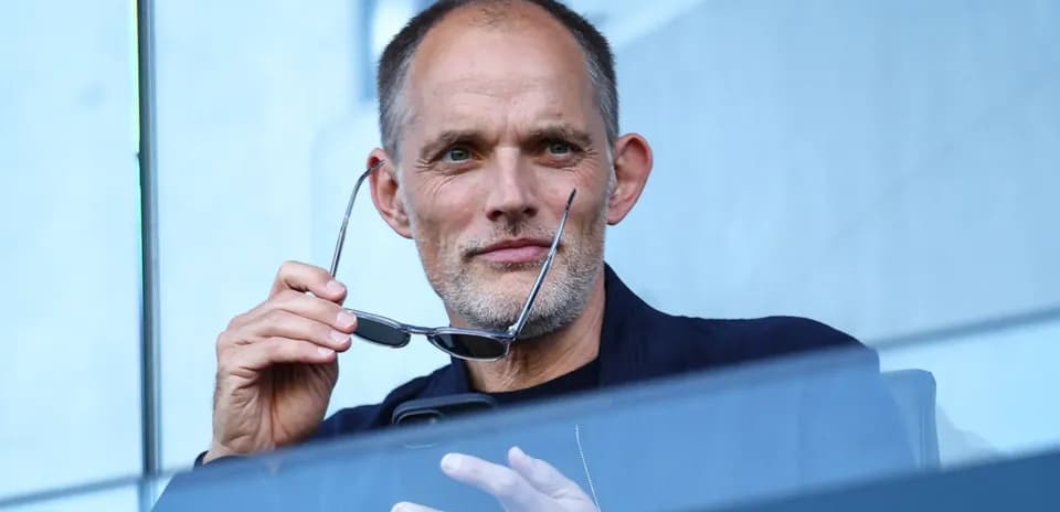 Man holding glasses while using a phone