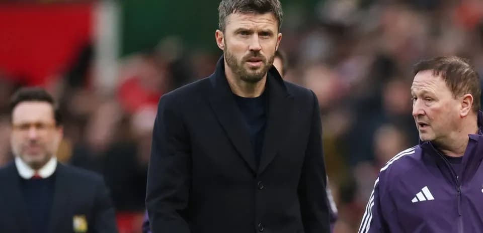 Coach walking alongside assistant during match