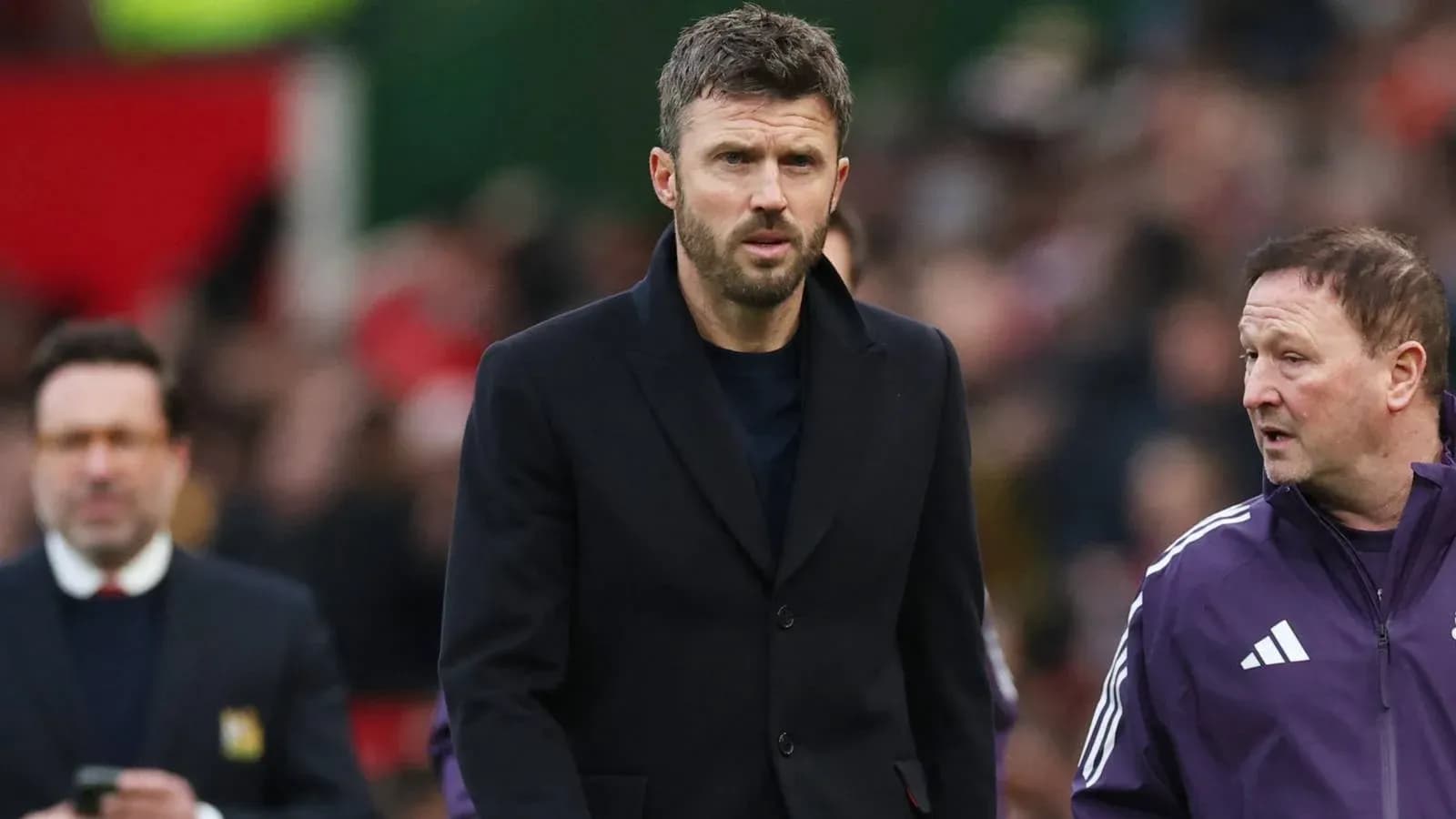Coach walking alongside assistant during match