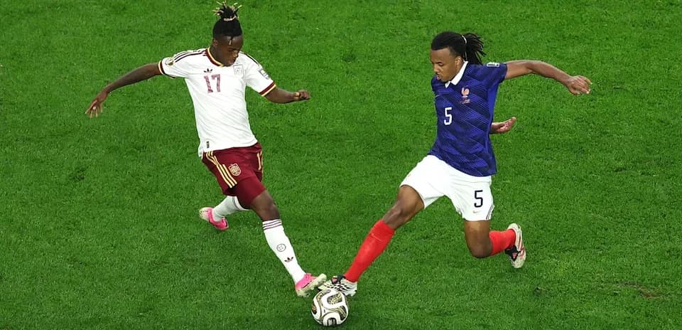 Two players contesting for the ball during match