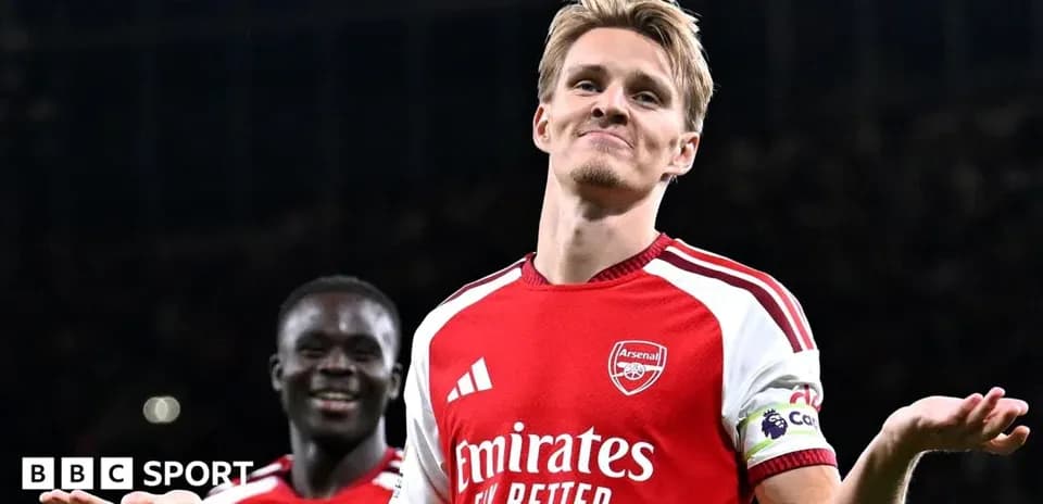 Arsenal player celebrating during match with teammate