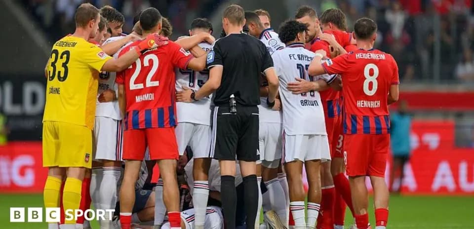 Players and referee gathered during match stoppage