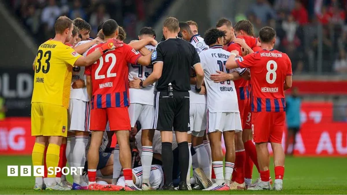 Players and referee gathered during match stoppage