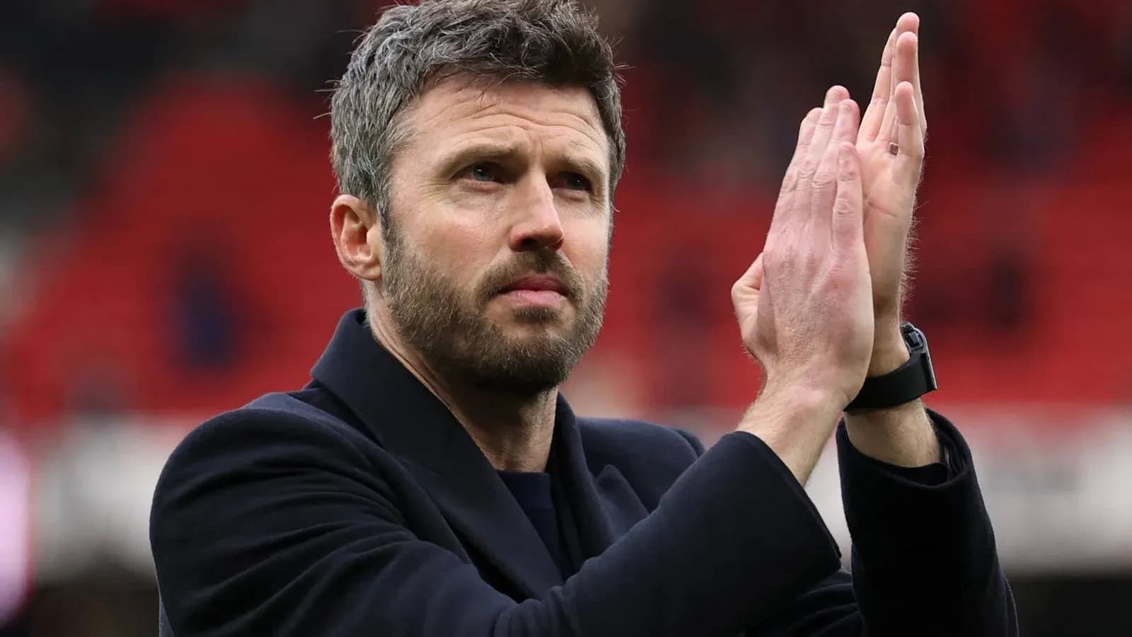 Coach applauding fans after a match